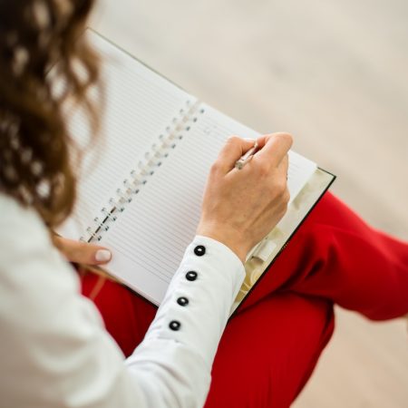 woman in red blazer holding white paper